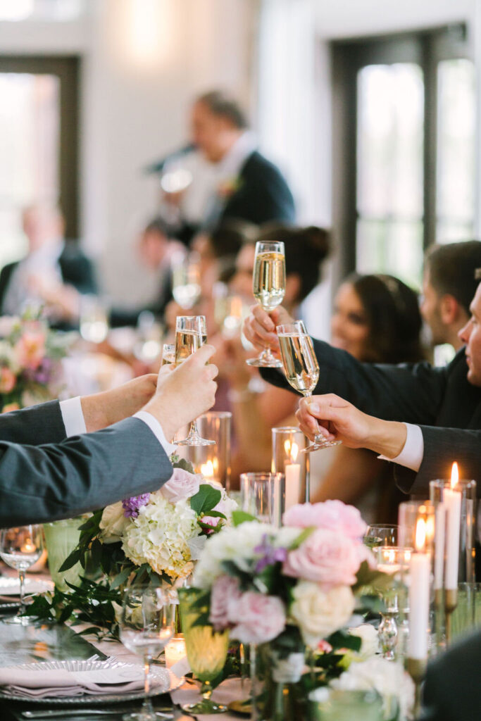 Wedding attendees tossing goblets at the reception