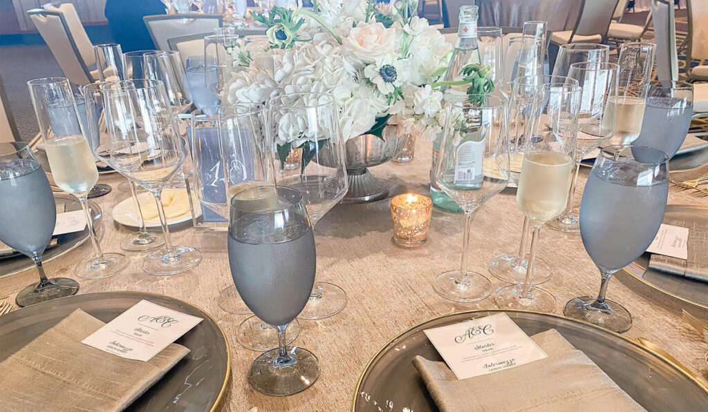Wine glasses at a wedding reception. Upgrade your wedding experience with experts.