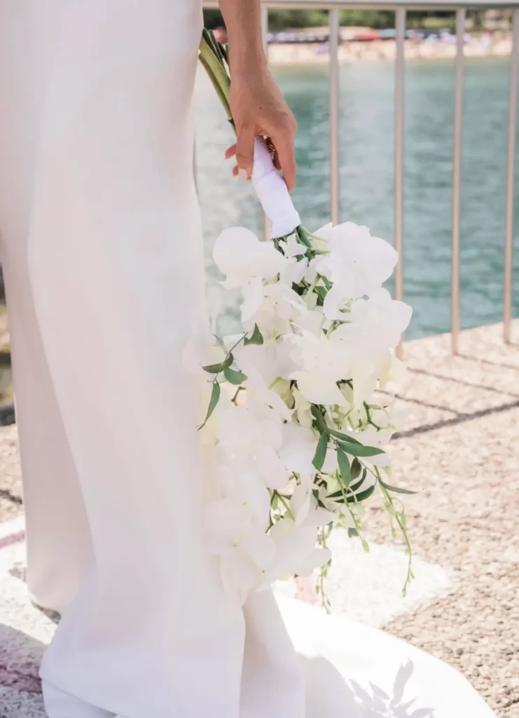 Bride holding a cascading white orchid bouquet, coordinated by Chicago's Finest Planners.