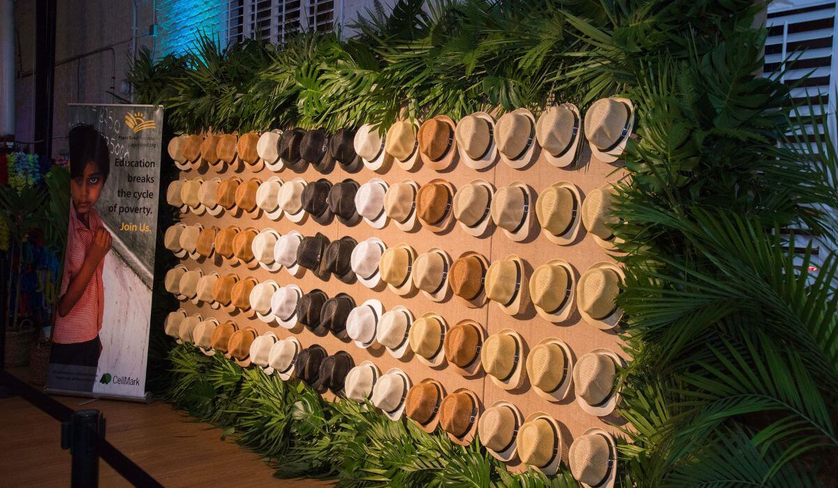 Array of assorted hats displayed on a wall at a charity event, creatively organized by expert Event Management.