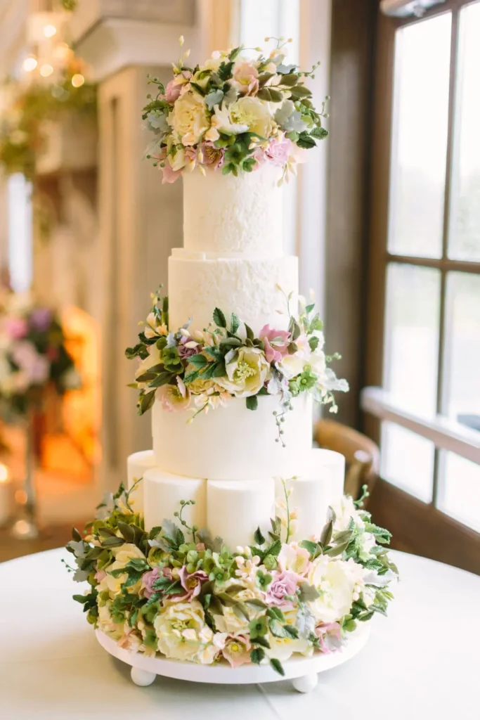 Elegant multi-tiered wedding cake adorned with pastel flowers by Chicago's Finest Planners.