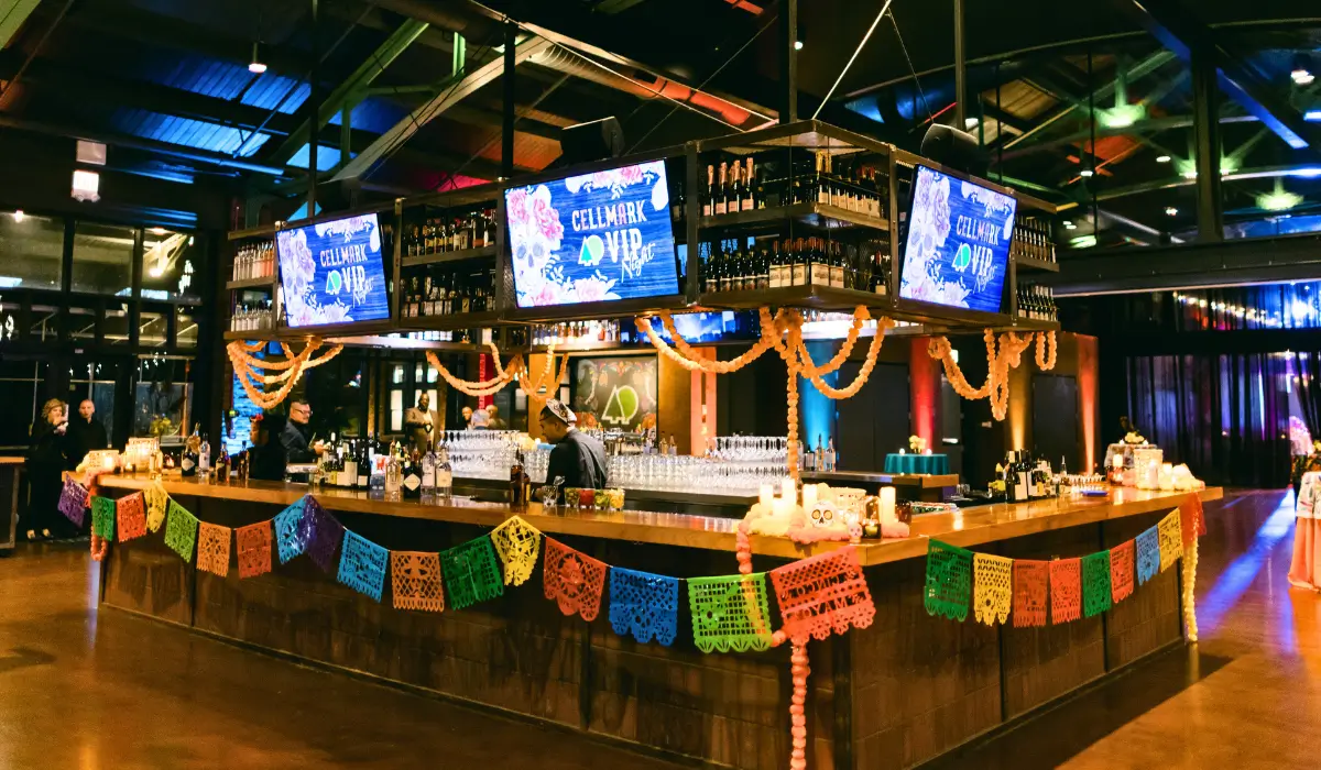 A vibrant bar setup with colorful decorations at a corporate event, showcasing creative ideas for corporate party planning.