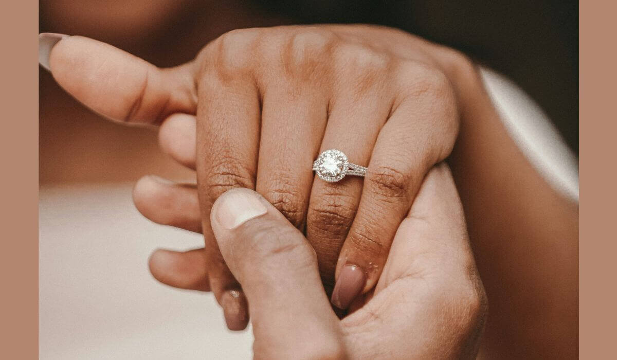 Close-up of hands holding, showcasing a sparkling diamond engagement ring, highlighting modern engagement trends.