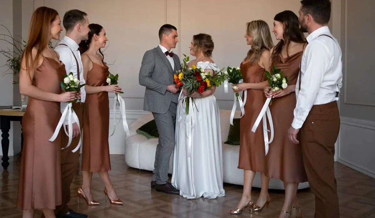 Bride and groom with wedding party in mocha-themed attire celebrating love and mocha mousse-inspired design elements.