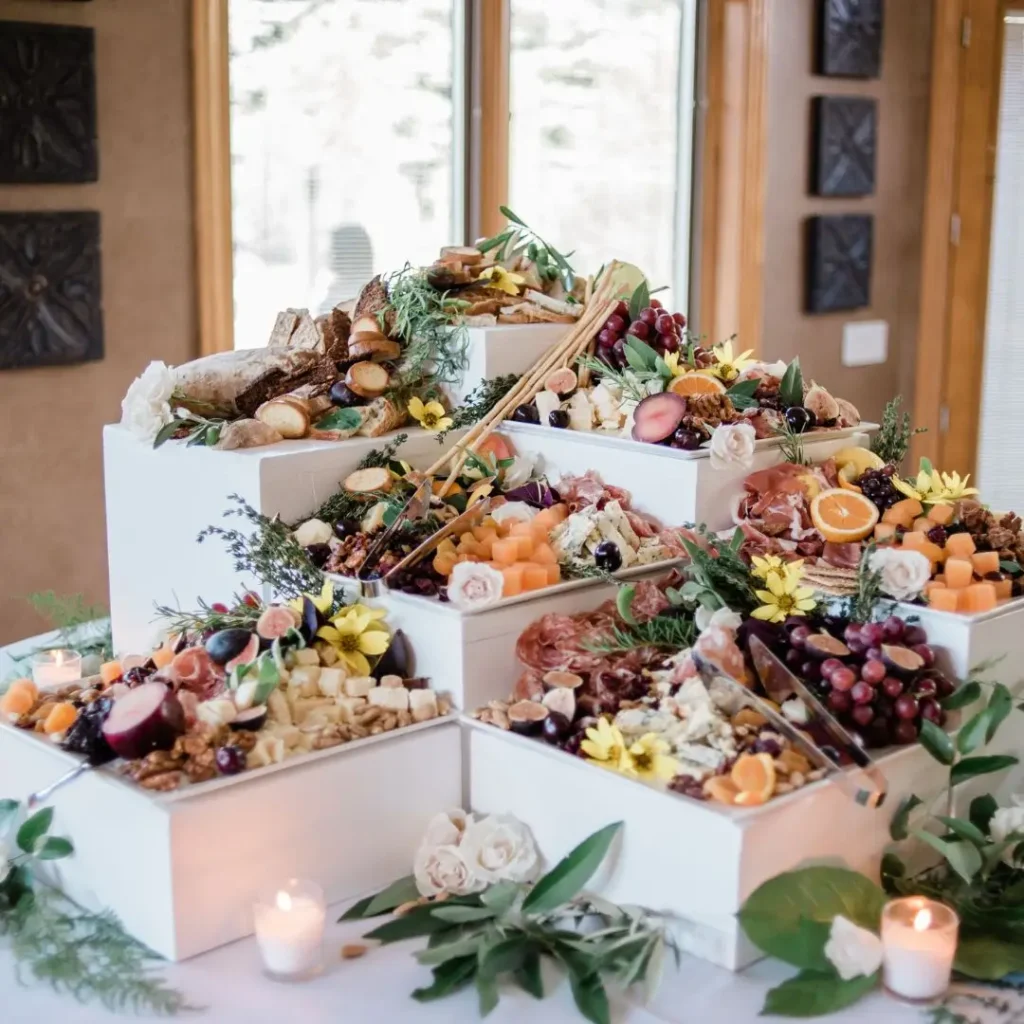 A beautifully arranged catering display by top wedding vendors featuring fresh fruits, cheeses, and artisanal bread.