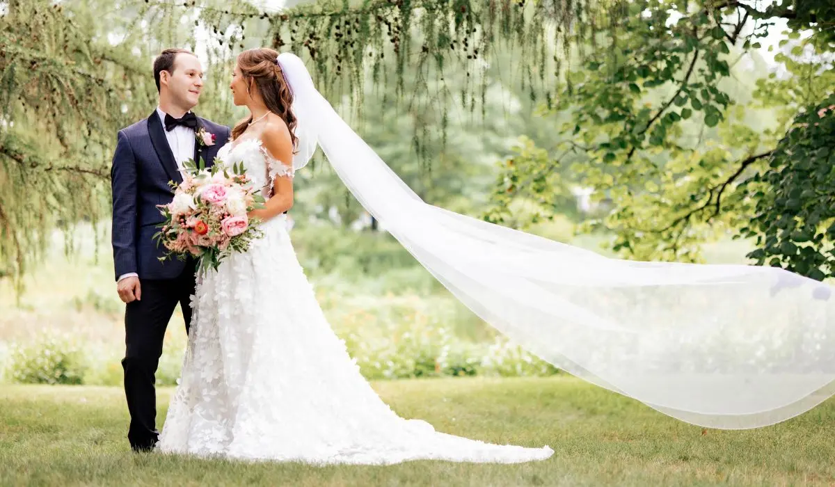 Beautiful bride and groom enjoying their wedding day, surrounded by lush greenery and romantic floral arrangements.