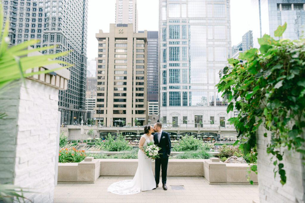 Couple walking hand-in-hand along Chicago waterfront with skyline view — a peaceful moment in their wedding planning timeline.