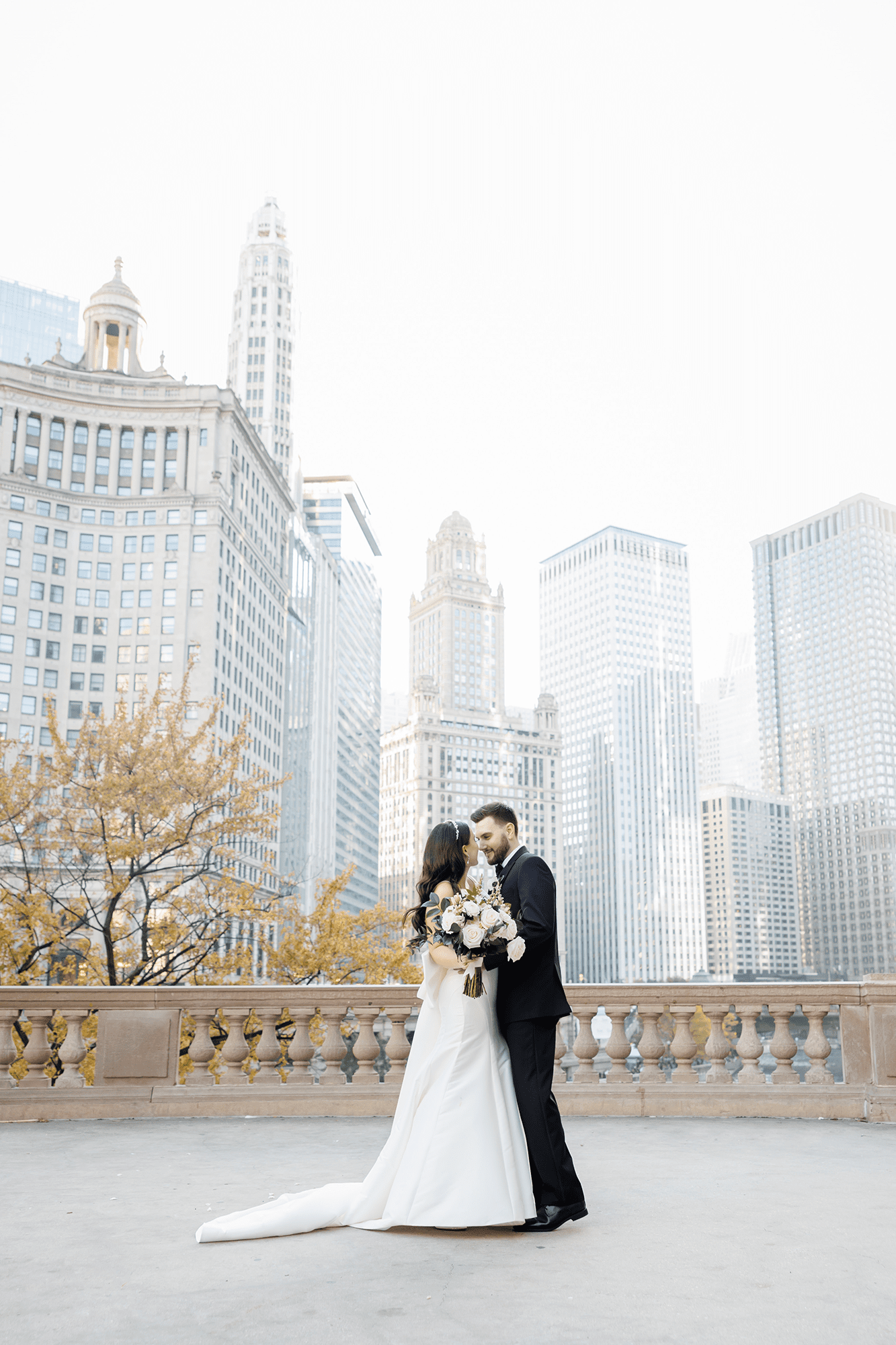 Couple walking along the Chicago Riverwalk during their wedding portraits as part of the Chicago wedding planning timeline.