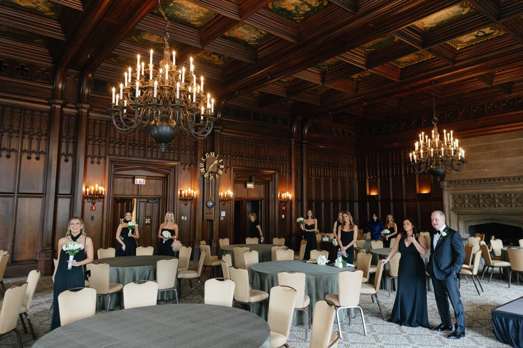 Wedding reception at historic chicago venue with green tables, chandeliers, wood paneling, and formal guest attire.
