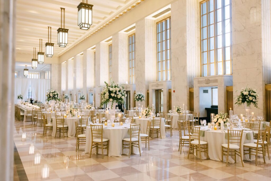 Luxury wedding with ivory linens, gold chairs, and lush white florals in The Old Post Office.