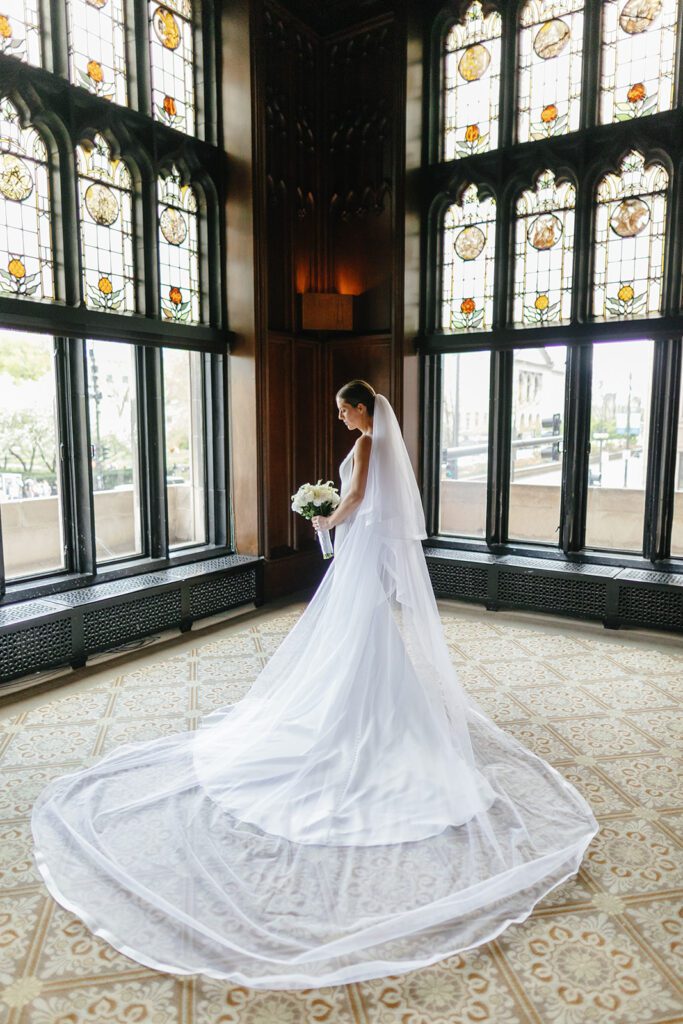bride infront of stained glass window at wedding in Chicago