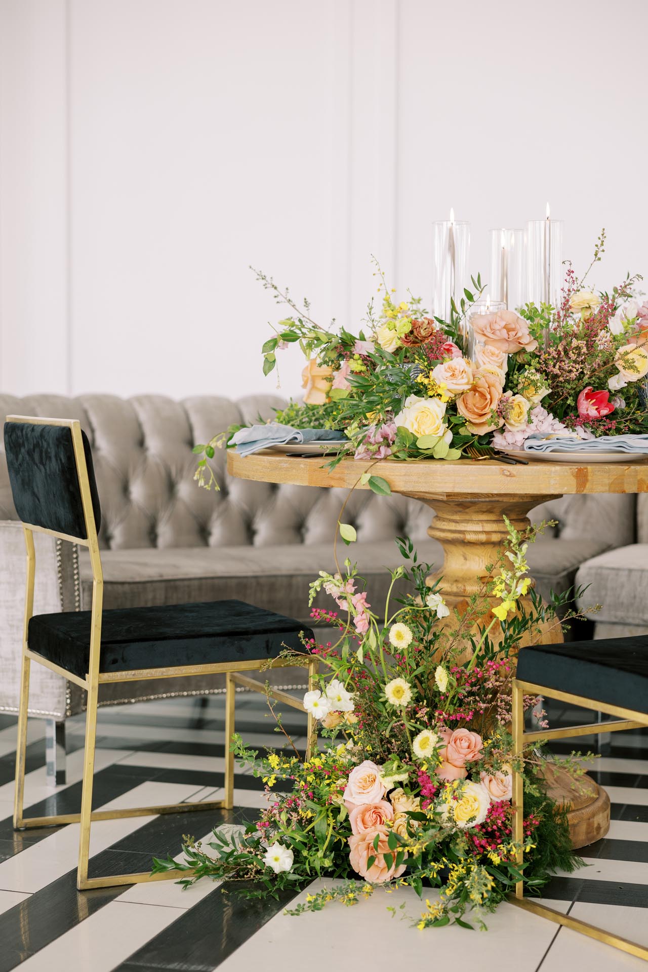 Romantic floral centerpiece with candles and velvet chairs at The Penthouse Hyde Park