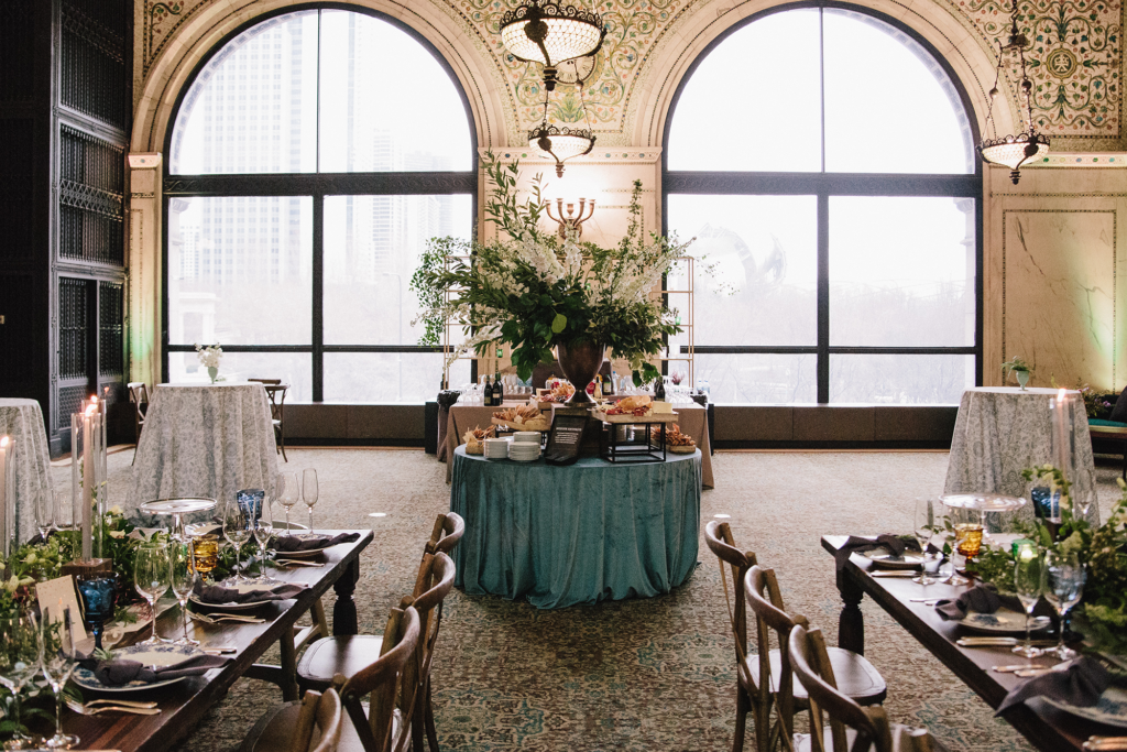 eal-draped buffet table surrounded by cocktail tables and long dining setups in GAR Hall, styled for a wedding reception at the Chicago Cultural Center.