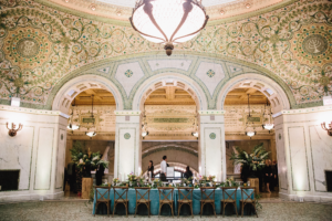 Elegant Chicago Cultural Center weddings featuring teal tablescape, mosaic arches, and historic architectural details.
