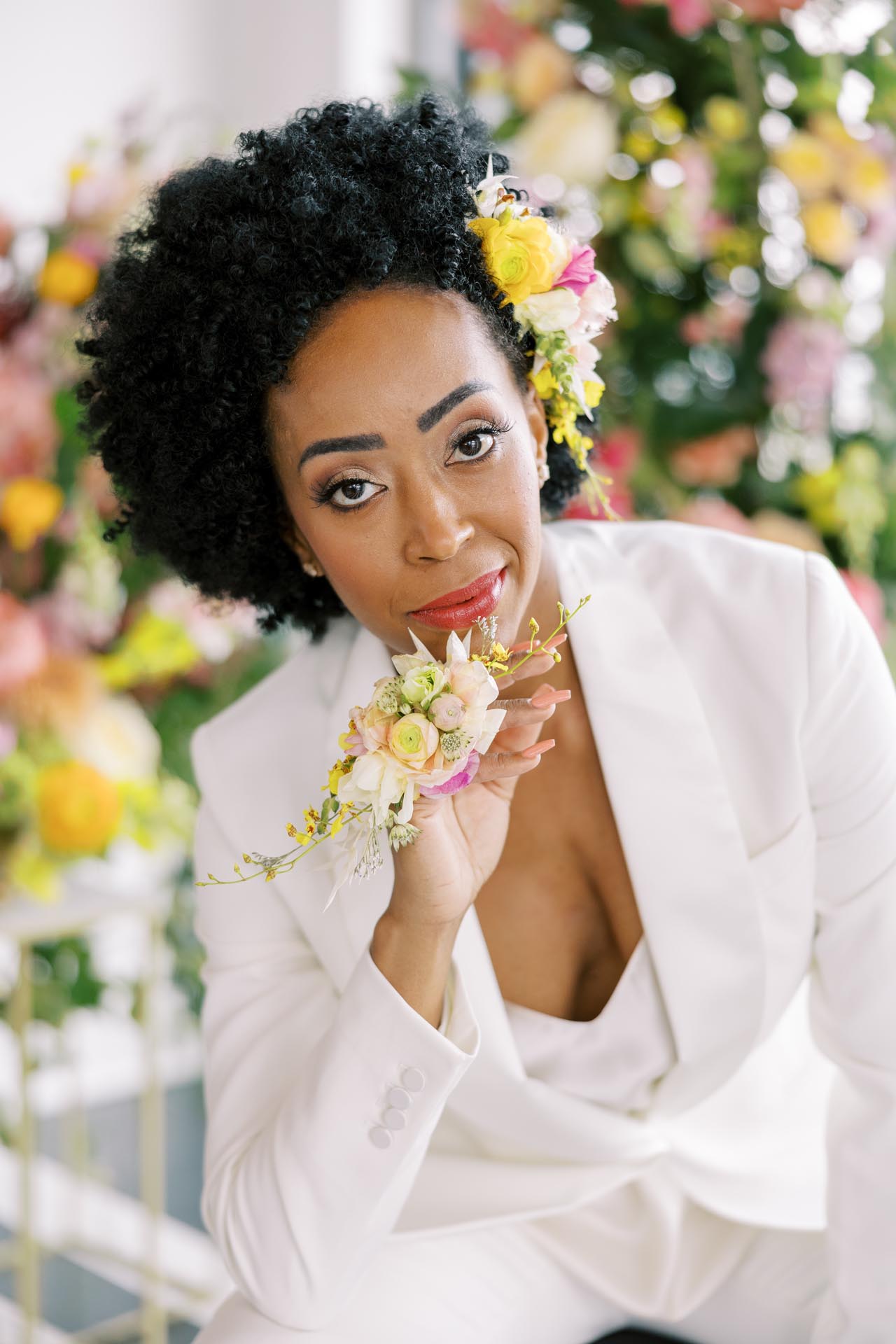 Chicago wedding editorial featuring white suit and vibrant floral styling.