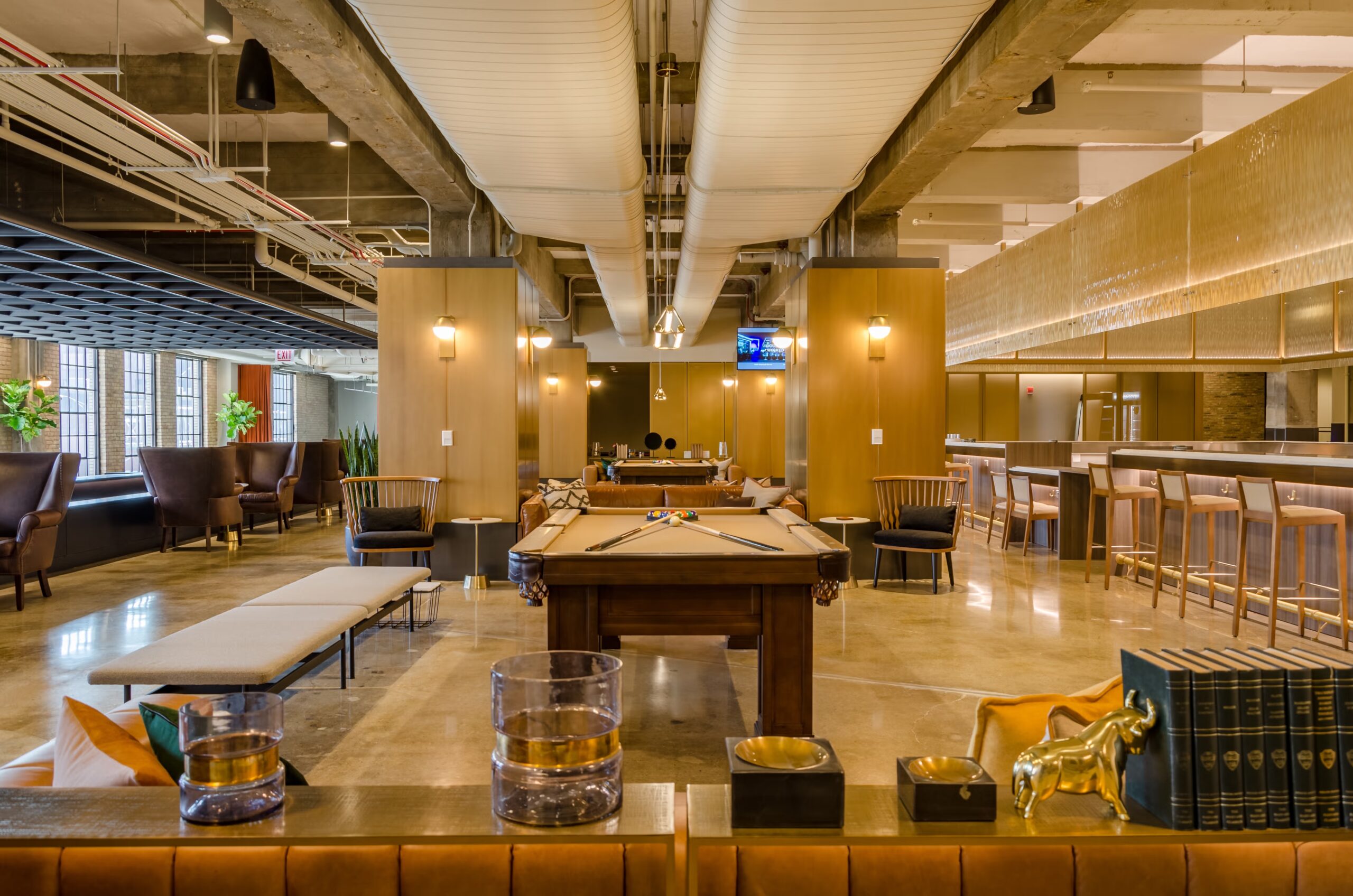 Upscale lounge with a wooden pool table, marble bar, and industrial-chic seating at Chicago’s Old Post Office — perfect for cocktail hour or after-party.