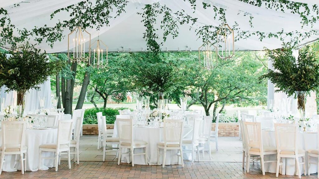green and white nature wedding inside of a white tent at chicago botanic garden