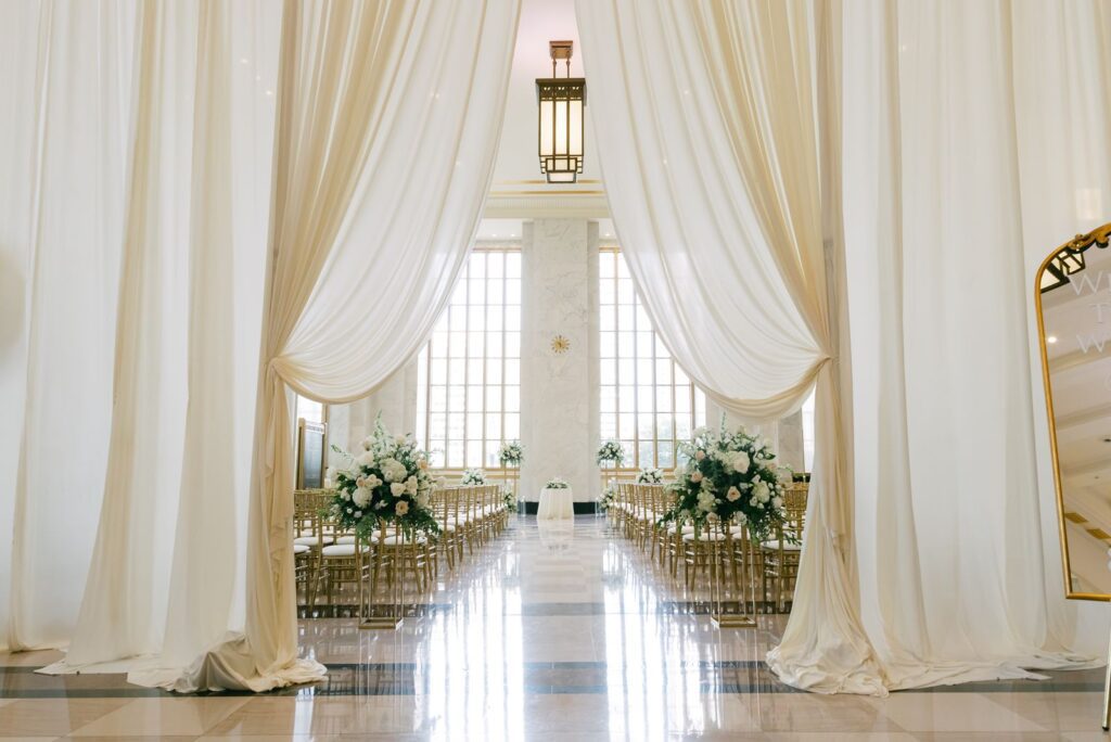 Editorial ceremony details featuring gold Chiavari chairs, blush florals, and marble architecture in a Chicago wedding venue.
