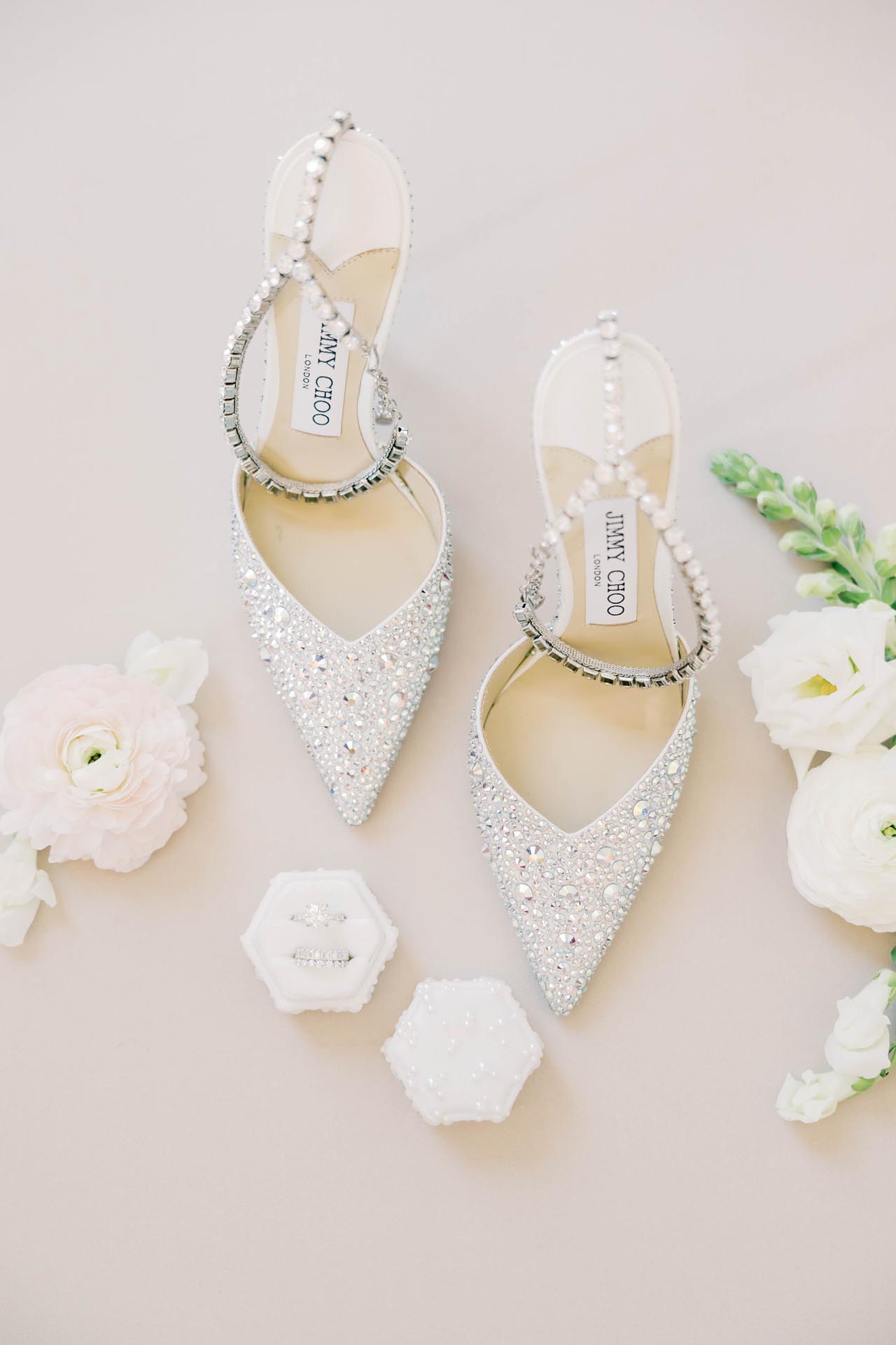 Luxury wedding accessories flatlay featuring designer shoes and ring boxes in Chicago.