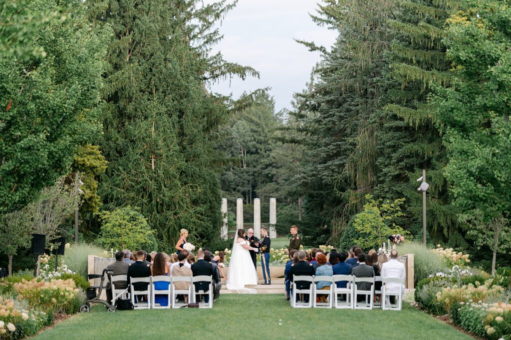 Bride and groom exchange vows during a wedding at the arboretum