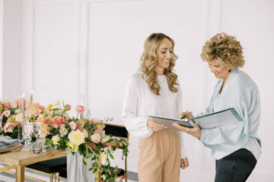 Two people reviewing wedding plans beside a luxury floral tablescape in Chicago, illustrating when to book wedding vendors for a 2026 celebration