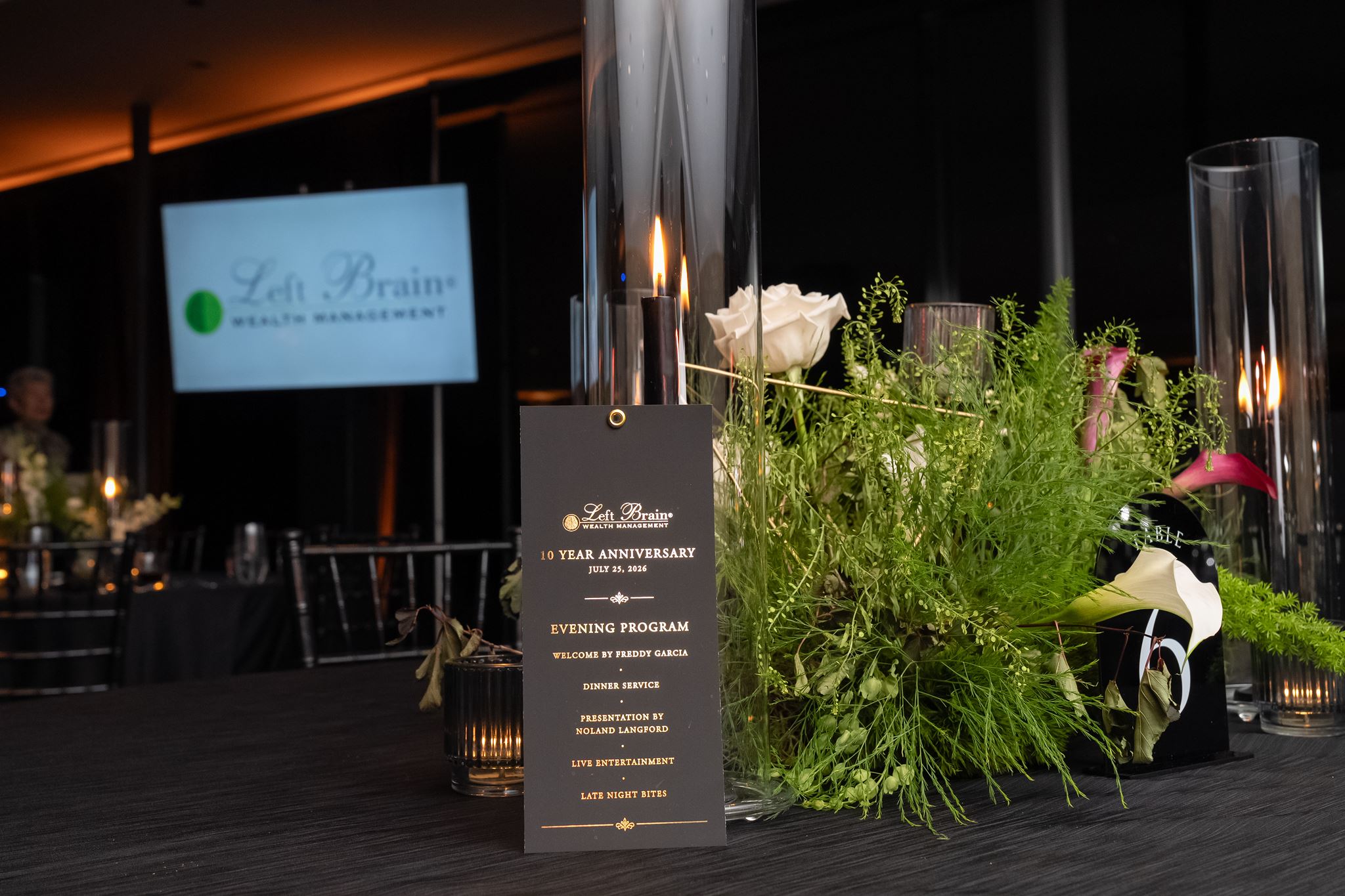 Modern greenery, white florals and candlelight designed for a 10-year corporate anniversary event