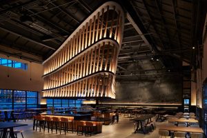 Modern Chicago restaurant with sculptural wood ceiling and sleek bar, ideal for weddings and corporate events.