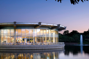Modern circular Chicago waterfront venue with twilight reflections, ideal for intimate weddings and upscale dinners.