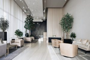 Minimalist Chicago lobby with glass orbs, sheer curtains, and neutral seating for refined guest arrivals and gatherings.