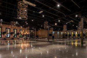 Modern Chicago venue with spiral light installations, potted trees, and elegant lounge seating for upscale events.