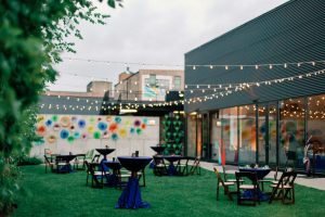 Outdoor Chicago courtyard with string lights, modern architecture, and vibrant art for weddings and corporate events.