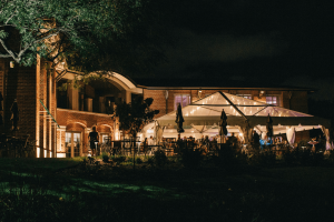 String lit tented event outside a historic Chicago venue, perfect for weddings, galas, and corporate dinners.