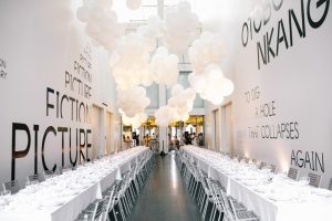 Art-forward Chicago gallery venue with silver tables, balloon clusters, and bold typography for modern banquets.