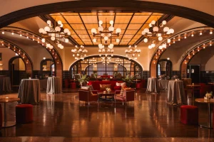 Elegant Chicago event venue with chandeliers, amber glass ceiling, and lounge seating for weddings and galas.