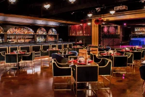 Upscale Chicago bar and lounge set for private events, with black and gold accents and ambient lighting.