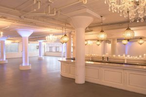 Elegant Chicago event space with chandeliers, mirrored bar, and ambient lighting for weddings and upscale gatherings.